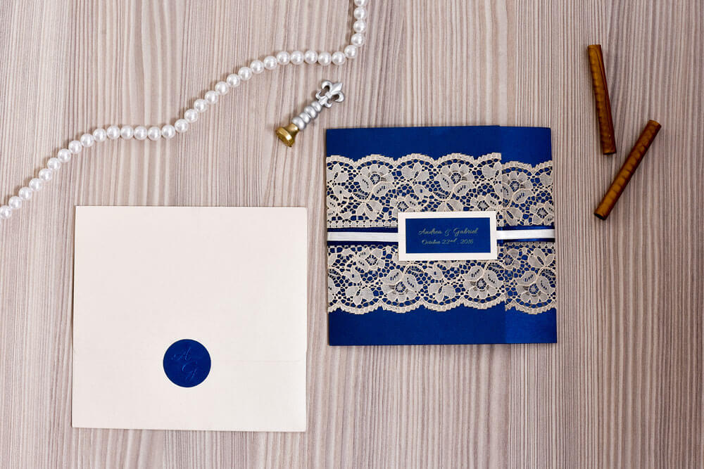 Invitación de matrimonio azul rey con encaje y placa de nombres