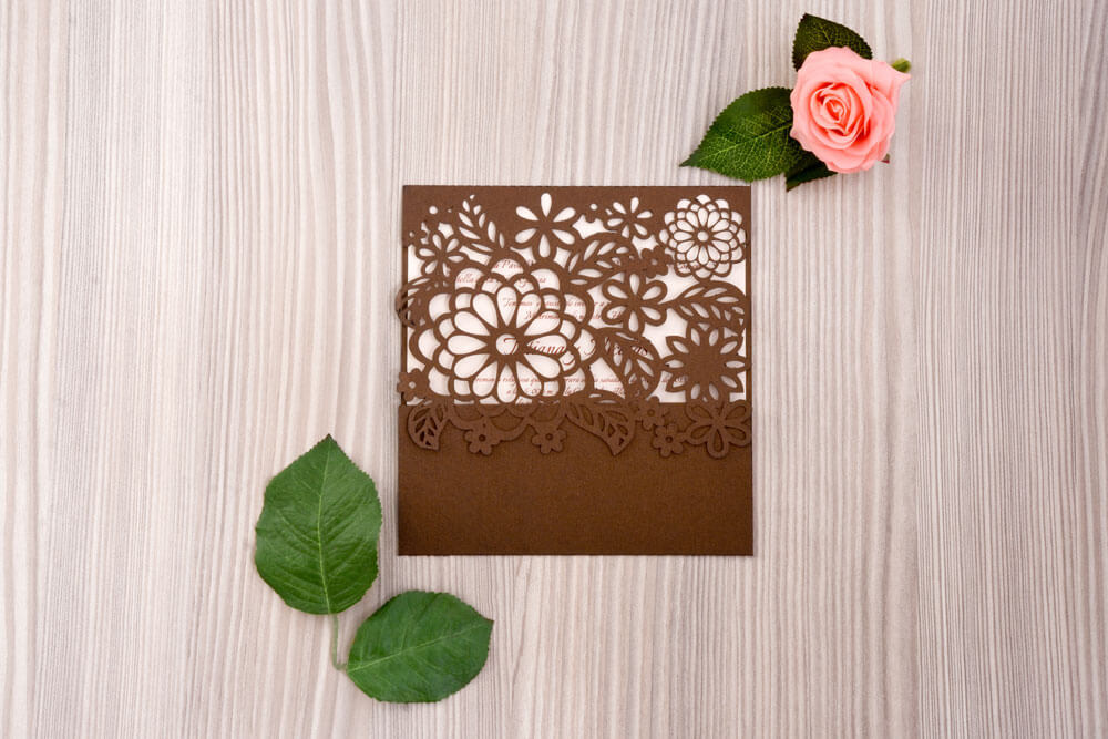 Invitación de matrimonio troquelada con flores en papel chocolate